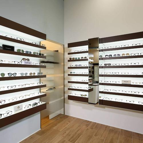 Classical and elegant wall eyeglasses shelves for an optical shop in Germany.
