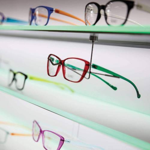 Magnetic wall eyewear shelf with white and colored LED lighting.